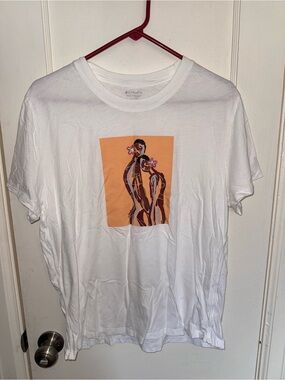 Athleta Women’s White Tee with Peach Graphic Figure Panel. Great condition. L